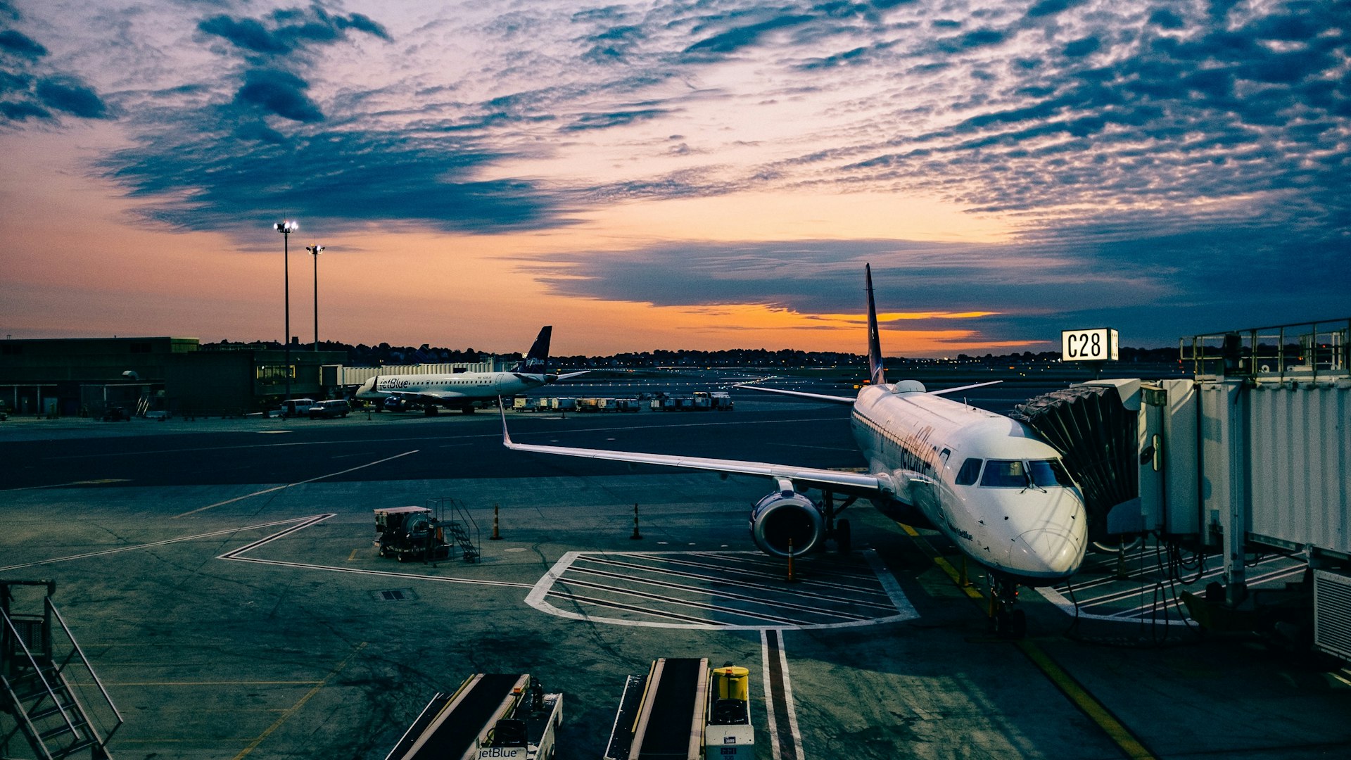 Airplane landing at sunset on the runway — view from Airport Cafe
